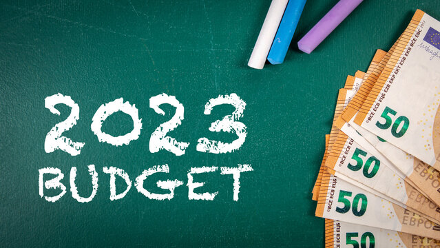 2023 budget. Euro money and colorful pieces of chalk on a chalkboard background - Powered by Adobe