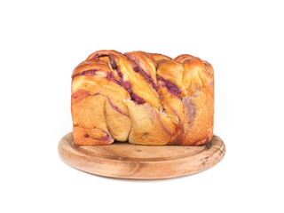 Braided babka brioche bread with purple sweet potato filling on wooden plate