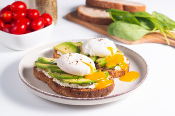 Two avocado open sandwiches with egg. Keto and diet concept. Healthy toast food for breakfast.