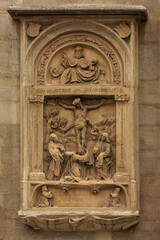 Fototapeta na wymiar The bas-relief on the wall of the cathedral in Vienna in Austria close-up. Nice view of the religious, Gothic architecture and historical art.