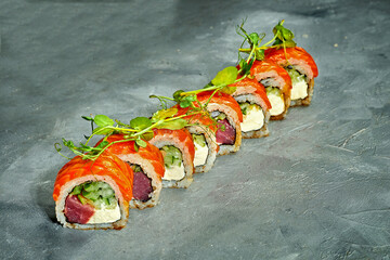 Sushi roll with tuna, salmon, cucumber and cream cheese on a gray background. Selective Focus. Sushi Menu
