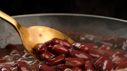 Red kidney beans. Cooking red kidney beans close up. Chef stir beans with spoon