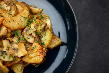 Fried potatoes with mushrooms and herbs on a plate