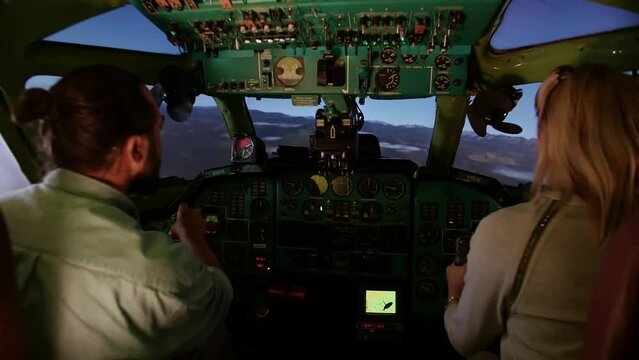 Man and Woman in the airliner cockpit. Training simulator pilots of the plane of large airliners, Pre-flight preparation