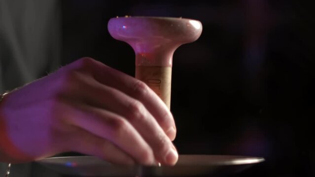 Hookah assembly. Putting bowl onto the tray.