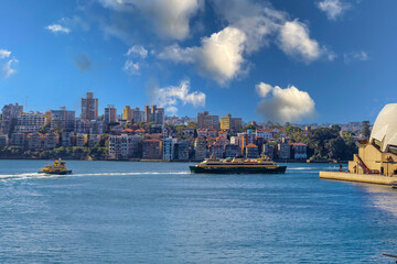 Panoramic view of Sydney Harbour NSW Australia beautiful bridge and ferry with Sydney CBD office and apartment buildings in view. Ferry in Sydney Harbour NSW Australia. 