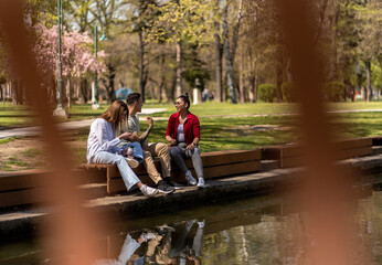 Group of young friends talking in downtown near river