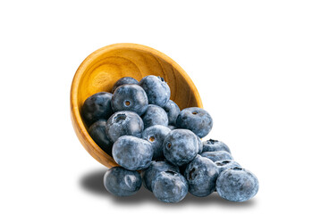 Pile of fresh blueberry in wooden bowl isolated on white background with clipping path.