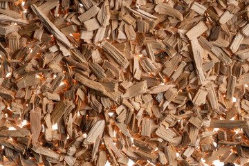 Background of brown dry wood splinter. Wooden chips and slivers. Crushed, chopped wood tree for...