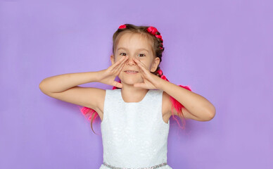 Sale, discount, win, winner's concept. An impressed, happy, cute girl with pink hair looks into the camera with her mouth open and screams against purple background. Advertising of a children's store