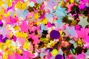 Bright pink, white, purple and gold stars and circles. Pattern from sequins, tinsel, confetti for...