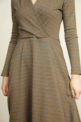 Serie of studio photos of young female model in brown tweed dress, autumn winter fashion collection.