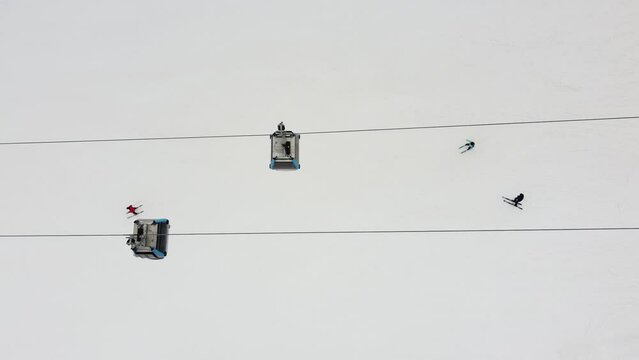 Aerial top view of a ropeway above people skiing on a mountain in Jahorina, Bosnia and Herzegovina