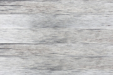 Gray wooden background of weathered distressed rustic wood with faded white paint showing wood grain texture.
