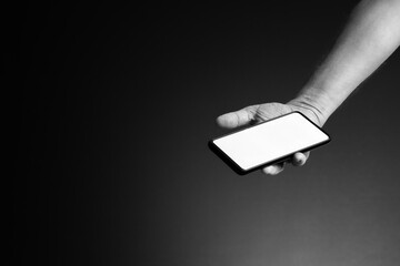 Hand holding smart phone in palm with blank white screen and copy space