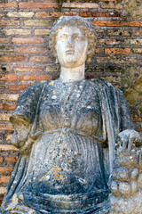 Portrait of Roman goddess Fortuna Annonaria statue, located at the domus of Fortuna Annonaria situated in ancent Roman village ruins of Ostia Antica  - obrazy, fototapety, plakaty