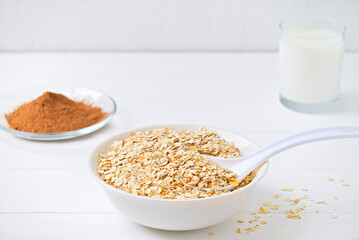 plate of oatmeal and cocoa carob and a glass of milk. healthy food. diet.