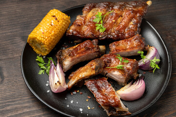 Grilled ribs with barbecue sauce and ketchup and grilled vegetables
