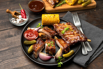 Grilled ribs with barbecue sauce and ketchup and grilled vegetables
