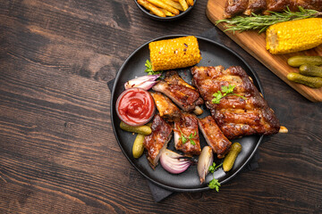 Grilled ribs with barbecue sauce and ketchup and grilled vegetables

