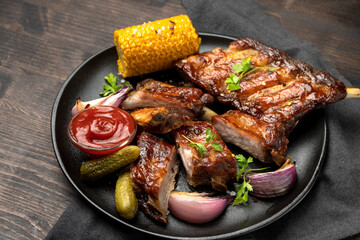 Grilled ribs with barbecue sauce and ketchup and grilled vegetables
