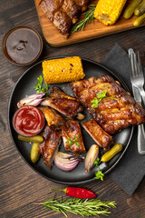 Grilled ribs with barbecue sauce and ketchup and grilled vegetables
