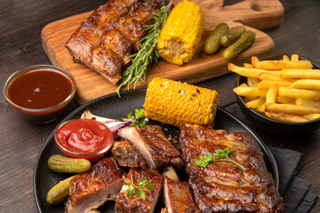 Grilled ribs with barbecue sauce and ketchup and grilled vegetables

