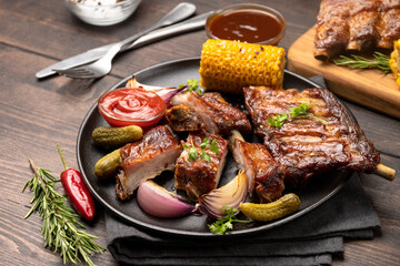 Grilled ribs with barbecue sauce and ketchup and grilled vegetables
