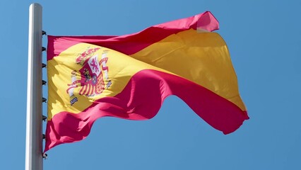 Spain, flag is fluttering in the wind photo on the background of the sky, outdoors. National flag