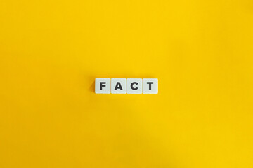Fact Word on Block Letter Tiles on Yellow Background. Minimal Aesthetics.