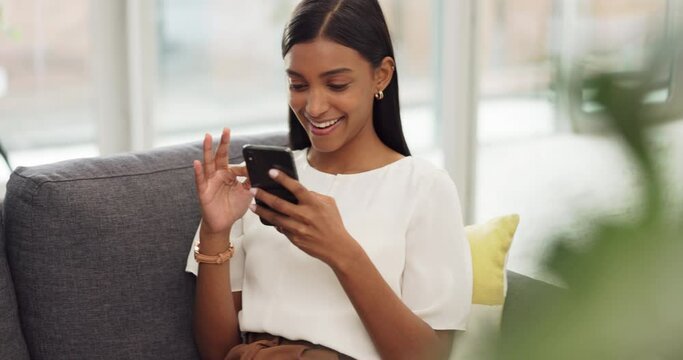 Happy Girl With Phone Relax On Sofa Or Living Room Couch While Laughing Or Smile At A Meme. Young Woman With Mobile At Home, House Or Apartment Doing A Internet Or Web Search For Funny Comedy Videos