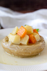 Artichokes with olive oil on wood background. Traditional Mediterranean cuisine delicacies. local name zeytinyagli enginar. Close up