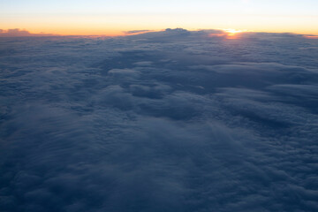 Fototapeta na wymiar Clouds from an airplane window