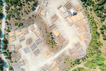 Aerial view of sawmill with timber, chopped  a lot of pine tree wood logs. Top, drone view