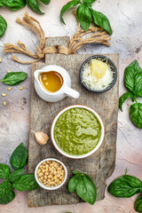 bowl with green pesto pine nuts, parmesan and garlic. vertical image. top view. place for text