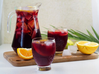 Pitcher of Sangria, two glasses of drink and fruit