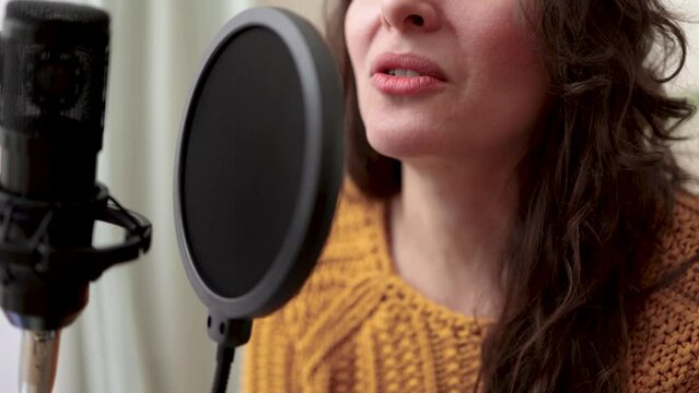 Young woman dubbing voiceover for broadcast stream live show