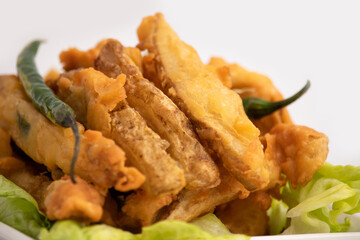 Indian Street Food Sliced Crispy Fried Potato Wedges Also Called Aloo Bhajji, Alu Bajji, Aaloo Pakoda or Pakora Made Of Bengal Gram Flour Besan Coating Are Famous Tea Time Evening Time Appetizer