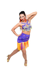 A brunette woman dances in chic outfit on a white background.