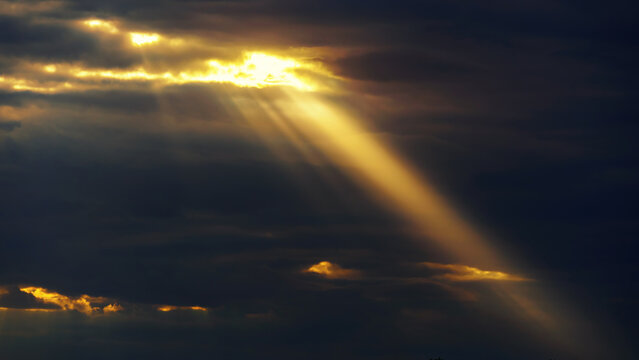 bright sun ray through dark dramatic sky with storm clouds, extreme weather sky for abstract background © soleg