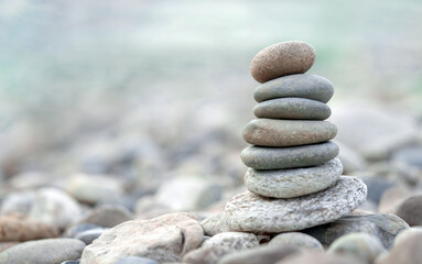 Fototapeta na wymiar Pyramid of sea pebbles. Zen stones. Life balance, meditation, spa, calmness, harmony concept
