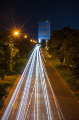A vertical view of the car lights from a long exposure in a street photography with street lights.