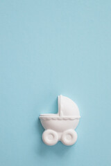 A plaster figure of a baby carriage on a colored background