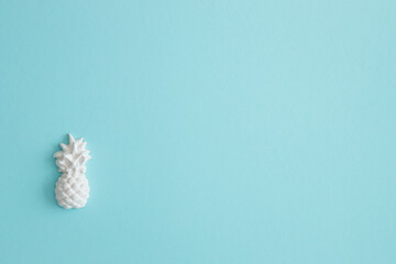 A plaster figure of a pineapple on a colored background
