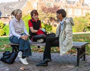 Fototapeta premium Teenage Students: Class Concerns. College friends talking with their teacher during recess. From a series of high school student related images.