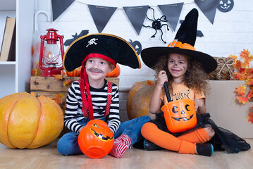 Fototapeta premium Children play with pumpkins. Holiday halloween
