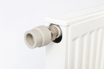 detail of a pvc fitting screwed to a heating radiator, plumbing repairman concept, on isolated white