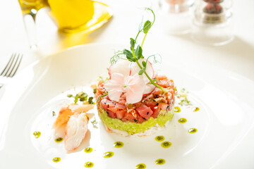 salmon tartare with avocado and edible flowers