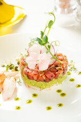 salmon tartare with avocado and edible flowers