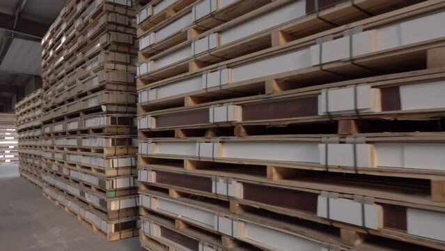 MDF and chipboard factory warehousing, production, manufacture and woodworking industry concept - chipboards processing.
